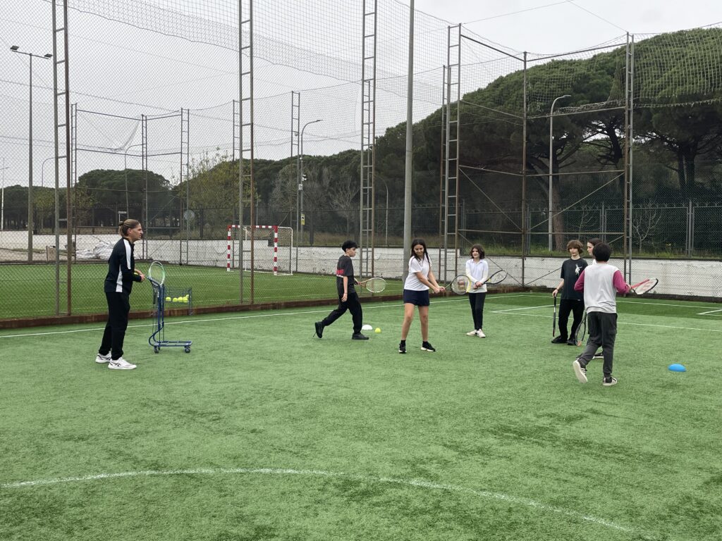 Teacher and students playing squash peacefully on a cloudy day.